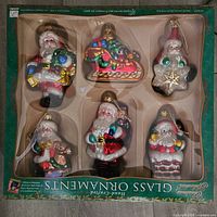 Photo of the six hand-crafted glass Christmas ornaments in original packaging showing three ornaments in the top row and three in the bottom row.