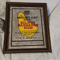Full view of vintage Mount Gay Barbados rum framed mirror with branding and logo visible on reflective mirror surface.