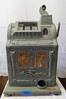 Front view showing entire slot machine on white backdrop, decorative front panel, coin tray and base