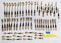 Full view of 58-piece flatware set including long spoons, forks, knives, and small spoons arranged on white surface.