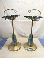 Front and side view of two ceramic leaf ashtrays mounted on tall brass floor stands showing size and design.
