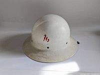 Front and angled view of the white WWII Air Warden Civil Defense helmet showing exterior surface and shape.