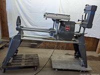 Full system assembled on floor with lathe bed, table saw top, disc sander and chop saw arm