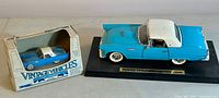 Photo showing diecast turquoise and white 1957 Ford Thunderbird model next to its original boxed ERTL 1957 Thunderbird vintage vehicle model.