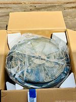 View of the pruning blade bowl inside the box with protective foam and plastic wrapping, showing the stainless steel body.