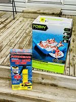 Both product boxes displayed on wooden deck