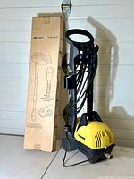 Karcher 390 pressure washer unit standing next to the boxed OCAP scrub cleaning kit.