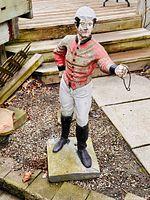 Front view of full statue showing posture, colors and base.