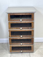 Front view of antique side cabinet with 5 tongue and groove drawers, painted finish with wear.