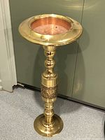 Full view of the brass and copper pedestal plant stand showing the height, shape, and finish.