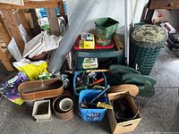 Overview of gardening lot including pots, tools, chicken wire, string, and stool bench