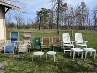 Outdoor image of 10 lawn chairs and tables arranged in a row on grass showing condition and style.