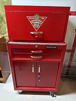 Front view of assembled top chest and bottom cabinet showing red finish, chrome handles, and Canadian Tire Corps decal.