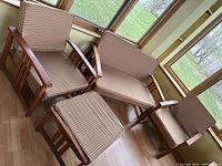 Overhead view of the three-piece teak set arranged in sunroom by windows