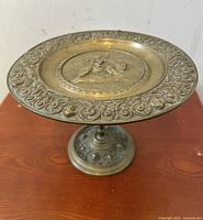 Full view of bronze tazza with sculpted cherub on bear and ornate rim and base patterns