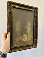 Side view of the framed print showing the depth and ornate frame detail
