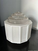 Front side view of the Art Deco glass ceiling lamp shade showing vertical ribbed panels in opaque white glass and stepped clear glass top.