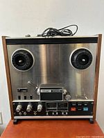 Front view of TEAC 3300S reel-to-reel tape deck with two empty spindles, control knobs and VU meters
