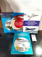 Front covers of all four Dover coloring books displayed upright
