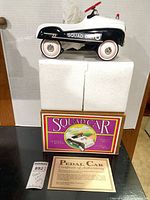 model car on foam supports, original box below, certificate visible