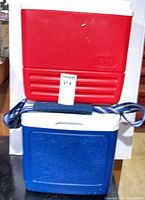 Stacked red and blue Igloo coolers front view