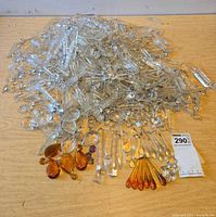 Pile of assorted clear and colored glass prisms spread on table