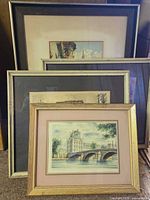 All four framed prints stacked showing varying frame finishes and subjects