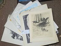 Stack of seven loose and framed prints on floor