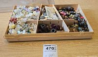 Overview of divided tray showing assorted buttons of various materials and colors