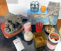 Group shot showing bear sculpture, candlestick, various votive holders, boxed glass holders and candles