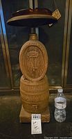 Full view of barrel ashtray with glass top and water bottle for scale