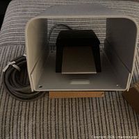 Foot switch inside protective guard with attached cable