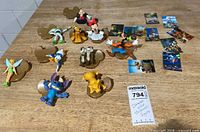 Group shot of all ten figurines, bases and art cards
