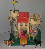 Front view of Fisher Price castle with accessories displayed
