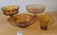 Group shot of all four amber glass pieces on table