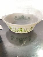 Side view showing exterior green daisy pattern and overall shape