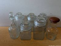 Group shot of all glassware including five canisters, decanter, carafe