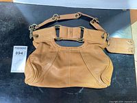 Front view of Hayden-Harnett tan leather handbag