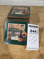 Stack of sealed coaster packs showing design and auction tag