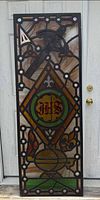 Full view of stained glass panel upright against door