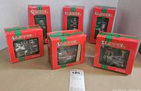 Six boxed Lionel ornaments displayed, fronts of boxes visible