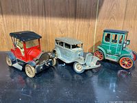 All three vintage toy cars grouped