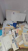 Pile of loose stamps, covers, souvenir sheets, folders and glassine sleeves