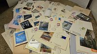 Pile of assorted first day covers and postcards