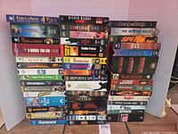 Single image showing two stacks of VHS movies with visible titles and quantity exceeding 45
