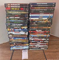 Full view of two tall stacks of DVD cases (over 50 titles)