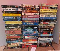 Three stacks of assorted VHS tapes showing spine titles