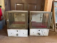 Front view of both display cases showing glass doors and marble drawers