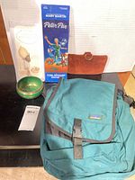 All items grouped: backpack, record sleeve, coin purse, photo album, Tibetan bowl