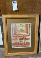 Full view of framed print in light wood frame